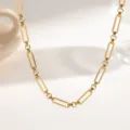 Minimalist gold stainless steel paperclip chain necklace detail, elegant metallic jewelry. - Interlocking Rings (XKN0252)