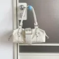White studded shoulder bag, Y2K punk style PU leather handbag with large buckle and double handles. - White