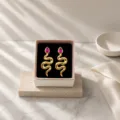 Closeup of retro gold snake earrings with pink gemstone in a box on marble surface. - Vintage Snake Stud Earrings (miou-488) / Wine Red