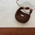 Brown knit mini handbag close-up detail showcasing cute horn button and cozy yarn texture. - Fits 3-10 Years / Coffee