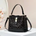 Stylish leopard print handbag with black patent trim, elegant crossbody and shoulder bag. - Coffee