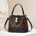 Leopard print bucket handbag with black patent leather trim and gold hardware crossbody - Brown