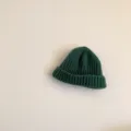 Close-up detail of dark green kids knit beanie, showing clear rib texture and soft warm fabric. - One Size / Green (Kids)