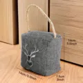 Herringbone fabric door stop detail showing deer embroidery and sturdy rope handle. - Deer Head Door Stop