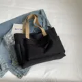 Black canvas tote bag for women, casual large capacity shoulder bag and commute handbag. - Black