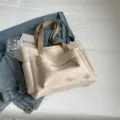 Casual large capacity canvas tote bag for women, retro commuter shoulder bag with front pocket. - Off White