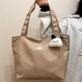 Solid color casual canvas tote bag with cute puppy pendant, large capacity shoulder bag for daily. - Brown