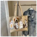 Beige canvas tote bag with cute cat prints and plush dog pendant, casual student shoulder bag. - Khaki