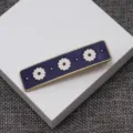 Retro enamel daisy hair clip detail view, featuring purple rectangle design with cute flowers. - Vintage Daisy Hair Clip