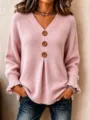 Close-up of women's V-neck knitted sweater with large buttons and chic ruffle cuffs design. - S / Tops / Pink