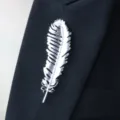 Elegant silver feather brooch pin for women, stylish lapel accessory for suits and dresses. - Feather Brooch / Silver