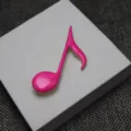 Close-up of hot pink enamel musical note brooch detail shot, perfect for clothing decoration. - Hot Pink