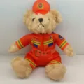 Cute firefighter teddy bear plush toy wearing orange uniform doll gift for kids room. - 25cm / 7