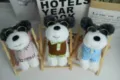 Detail shot of cute plush puppy toys wearing glasses and mini clothes, sitting on wooden chairs. - Stylish Glasses Style