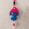 Detail shot of the cute blue Buddha plush pendant with red hair, hanging charm and soft texture. - Acala Buddha [Lanyard + Peace and Joy]