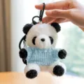 Dettaglio panda di peluche carino, morbido maglione lavorato, ciondolo per borsa. - Ciondolo Panda / Maglione Azzurro