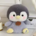 Close-up detail of the adorable soft plush penguin toy featuring gray fur and a wooden tag. - 17cm / Penguin