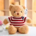Cute plush teddy bear toy in red and white striped sweater, soft stuffed doll gift. - Beige Flag Bear