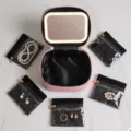 Pink portable travel jewelry storage box featuring built-in LED mirror and clear pouches. - 5 Sub-bags/LED Mirror Set / Pink