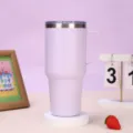 Detailed view of the 30oz stainless steel vacuum insulated tumbler with handle and lid. - 30oz / Purple