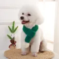 Green knitted pet scarf with pom-pom for dogs and cats, warm winter pet clothing accessory. - Green