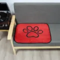 Washable red pet pee pad with cute black paw print design for dogs and cats comfortable mat - Red