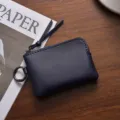 Dark blue leather mini coin purse with zipper and metal key ring, compact portable card holder. - Blue