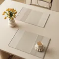 Detail view of beige waterproof placemat with elegant striped texture for dining table setup. - Qizhi