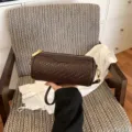 Retro brown woven cylindrical shoulder bag for women, stylish barrel crossbody handbag. - Coffee