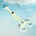 Detailed view of the white plastic piercing clamp, showing the ergonomic handle and secure lock. - Needle Tube Flat Pliers