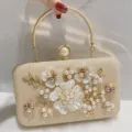 Elegant gold glitter pearl evening clutch bag with metal handle and floral rhinestone decor. - Champagne