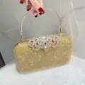 Gold rhinestone evening clutch bag detail showing sparkling crystals and metallic handle. - Gold
