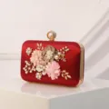 Elegant red satin evening clutch bag featuring handmade floral appliques, pearls, and gold branches. - Red