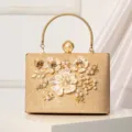 Gold evening clutch bag with elegant pearl flower decorations and metal handle for women parties. - Champagne