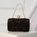 Black beaded evening clutch bag with elegant pearl handle and stylish metal clasp for women. - Black