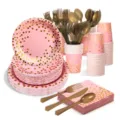 Pink and gold polka dot party tableware detail view, paper plates and cups close-up. - Pink