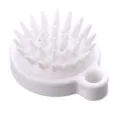 Vista dettagliata della spazzola per cuoio capelluto in silicone bianco con setole morbide. - Bianco