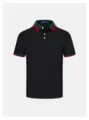 Vista dettagliata di una polo nera da uomo con colletto e polsini a righe rosse e verdi. - Taglia M / Nero