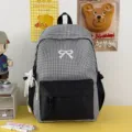 Sac à dos à carreaux noir et blanc avec broderie nœud, idéal pour l'école et le quotidien. - Avec Charme / Noir