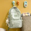 Casual green school backpack with cute white print and star pendant for daily use. - With Charm / Green