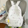 Casual white canvas backpack with cute cat print, perfect for school, travel and daily use. - With Charm / White