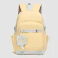 Sac à dos d'étudiant minimaliste élégant de grande capacité en jaune doux avec pendentif chat. - Jaune