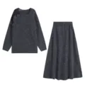 Detailed view of the elegant grey knit set featuring a floral sleeve and mesh shoulder design. - S / Set / Gray