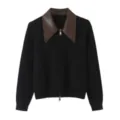 Contrast leather collar detail on black knit cardigan close-up showing exquisite texture and zipper. - M / Brown