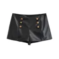 Close-up of black faux leather high-waisted shorts featuring decorative vintage bronze metal buttons. - XS / Bottoms / Black Pants