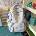 Stylish printed college schoolbag with cute pendant, large capacity backpack for women. - Backpack / With Pendant / Gray