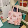 Pink printed canvas tote bag for women, stylish large capacity shoulder bag for daily casual use. - Shoulder Bag / With Pendant / Light Pink