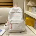 White casual backpack with pink letter patch and cute plush pendant for daily school commute. - With Charm / S / White
