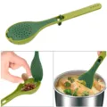 Green plastic seasoning spoon detail showing strainer design, spice filling and soup cooking use. - Green
