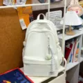 Simple large capacity travel backpack in white, lightweight school bag for students. - With Pendant / White